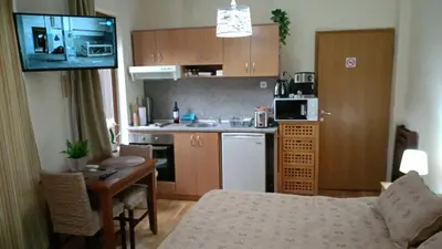 a kitchen and a living room with a table and a couch at Predela 1 - Studio 04 near Bansko Ski Lift in Bansko
