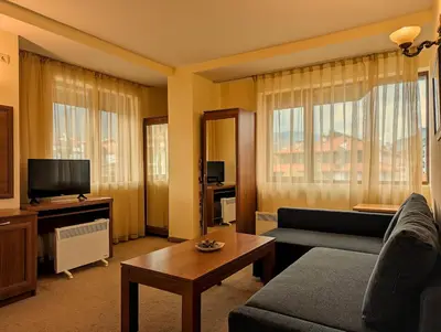 a living room with a couch and a tv at Great View Apartment near Gondola in Bansko