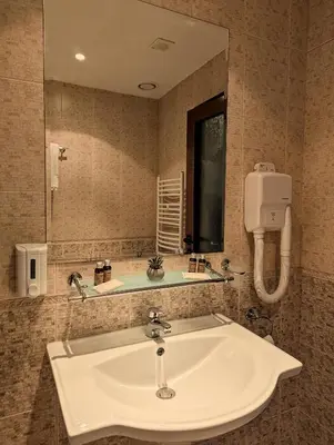 a bathroom with a sink and a mirror at Great View Apartment near Gondola in Bansko