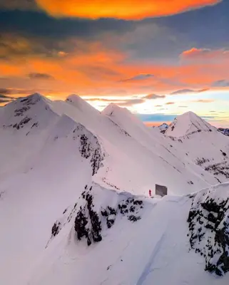 a snowy mountain with a person standing on top of it at Ski view suite Emerald Bansko in Bansko