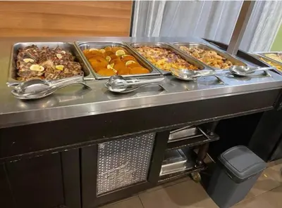 a buffet with many trays of food on a table at Private Apartments in Hotel Snezhanka in Pamporovo