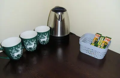 a table with three coffee mugs and a tea pot at Deers in Bansko