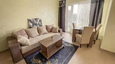 a living room with a couch and a table at Апартамент Панчо in Sofia