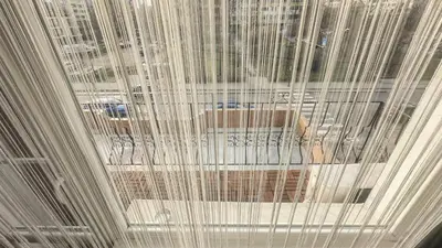 a ceiling with white curtains in a room at Апартамент Панчо in Sofia