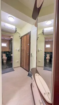 a bathroom with two mirrors and a sink at Апартамент Панчо in Sofia