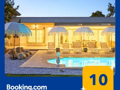 a house with a swimming pool with umbrellas at Villa Alma 1910 Starosel in Starosel
