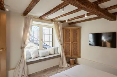 a bedroom with a window with a couch and a tv at Villa Alma 1910 Starosel in Starosel