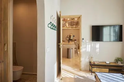 a hallway with a room with a table and a television at Villa Alma 1910 Starosel in Starosel