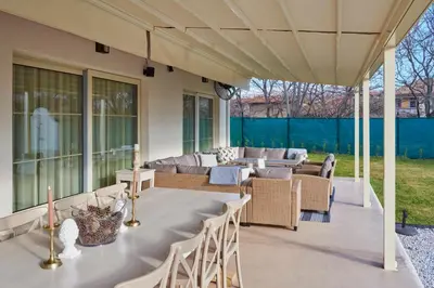 a patio with a table and chairs and a couch at Villa Alma 1910 Starosel in Starosel