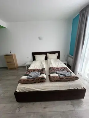 a bedroom with a bed with two pillows on it at ZaraApartHotel in Sofia