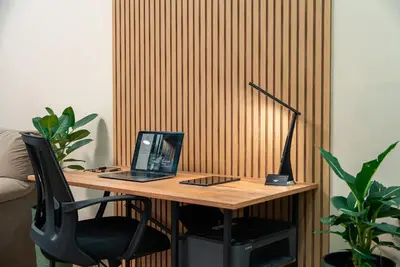 a wooden desk with a laptop computer on it at One-Bedroom apartment with Free Street Parking, Free Gym Pass and Office Setup in Plovdiv