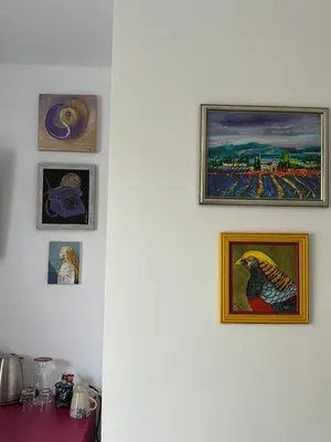 a group of pictures on a white wall at Бутик хотел ресторант брасери и релакс зона Сажитариус in Kyustendil