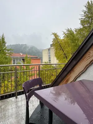 a purple bench sitting on top of a balcony at Бутик хотел ресторант брасери и релакс зона Сажитариус in Kyustendil