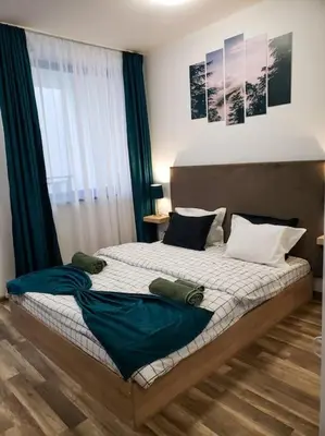 a bedroom with two beds and a window at Forest View Studio D25 in Borovets