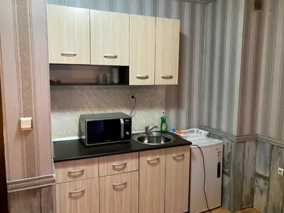 a small kitchen with a sink and a microwave at Polaris Inn Apartments in Bansko