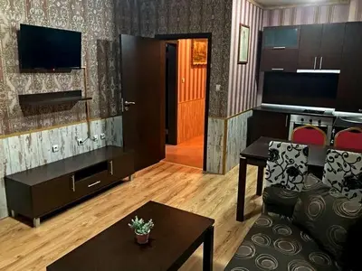 a living room with a couch and a table at Polaris Inn Apartments in Bansko