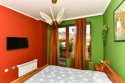a bedroom with green and red walls and a bed at Cedar Lodge III One BDRM Flat B2 in Bansko