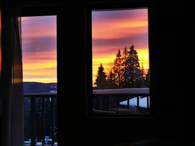a view of a sunset from a window at VIVA 4-A-16 ski to the door Grand Monastery in Pamporovo