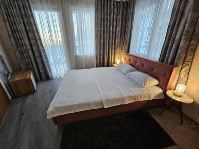 a bedroom with a large bed with a large window at VIVA 4-A-16 ski to the door Grand Monastery in Pamporovo