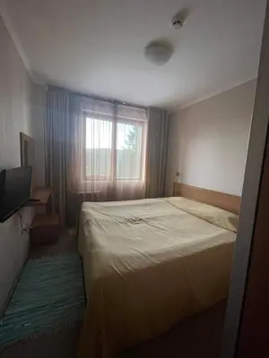 a bedroom with a large bed and a window at Apartments Hotel Snejanka Pamporovo in Pamporovo