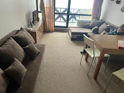 a living room with a couch and a table at Apartments Hotel Snejanka Pamporovo in Pamporovo