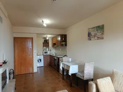a kitchen with a table and a dining room at Ski holiday in Lucky Pamporovo in Pamporovo