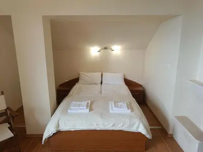 a bedroom with a bed with two towels on it at Ski holiday in Lucky Pamporovo in Pamporovo