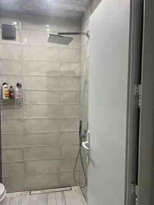 a bathroom with a shower with a glass door at Cozy and modern apartment Krasno selo, free parking in Sofia