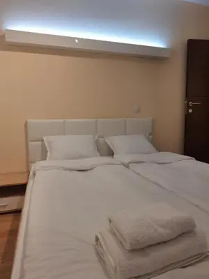 a large white bed with two towels on it at Danaya in Petrich