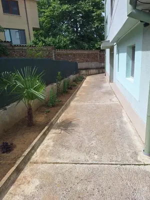 a sidewalk next to a building with a fence at Danaya in Petrich