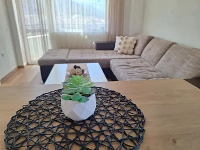 a living room with a table with a plant on it at Danaya in Petrich