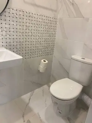 a white bathroom with a toilet and a sink at Boutique Magenta Pearl Apartment with free WiFi in Sofia