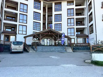 a white van parked in front of a building at Belvedere Holiday Club nice place in Bansko