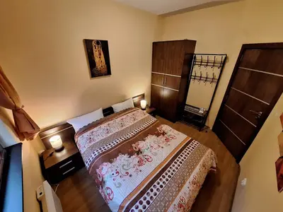 a small bedroom with a bed and a mirror at Top location ski-in ski-out and Swimming Pool in Bansko