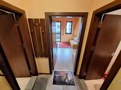 a hallway with a door open to a living room at Top location ski-in ski-out and Swimming Pool in Bansko