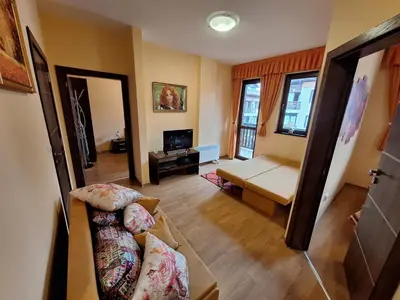 a living room with a couch and a table at Top location ski-in ski-out and Swimming Pool in Bansko