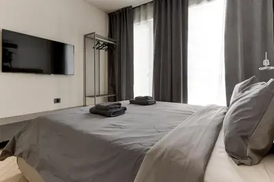 a bedroom with a bed with two towels on it at Amuse Bouche by Skabrin in Bansko