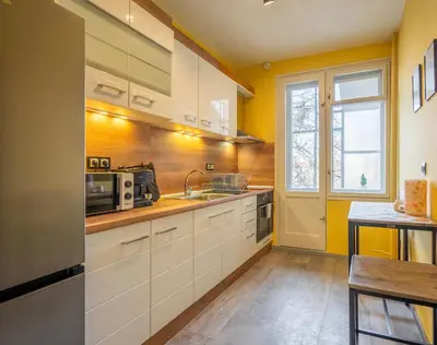 a kitchen with white cabinets and a sink at Golden Glow Residence in Sofia