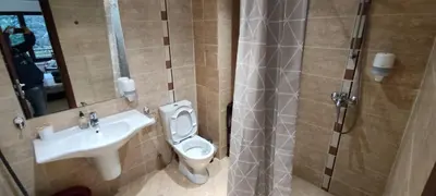 a bathroom with a sink and a toilet and a shower at Terra SP apartments-Razlog in Razlog