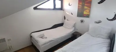two beds in a small room with a window at Royal Park SP apartments-Bansko in Bansko