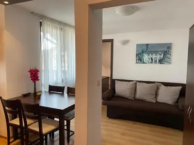 a living room with a table and a couch at Royal Park SP apartments-Bansko in Bansko
