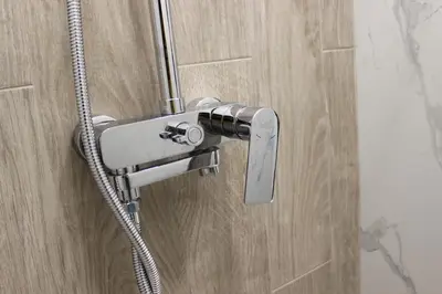 a shower with a shower head in a bathroom at Beautiful Apartment free Parking Garage in Plovdiv