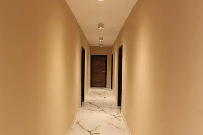 a hallway with marble flooring and walls with a corridorngthngthngthngthngth at Beautiful Apartment free Parking Garage in Plovdiv