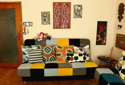 a couch with colorful pillows in a living room at Top-Center BestView Apartment in Sofia