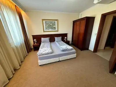a bedroom with a large bed in a room at Great apartments in Downtown in Bansko
