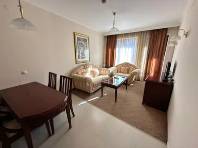 a living room with a couch and a table at Great apartments in Downtown in Bansko