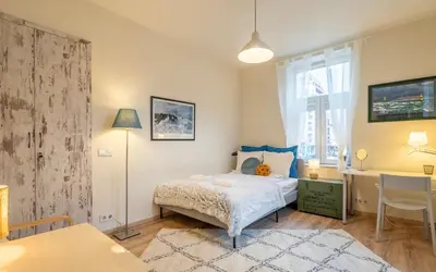 a bedroom with a bed and a desk and a window at 'Blue Sapphire House'- central&modern in Sofia