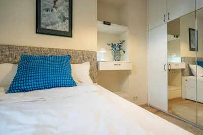 a bedroom with a bed with a blue pillow on it at 'Blue Sapphire House'- central&modern in Sofia