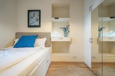 a bedroom with a bed with a blue pillow on it at 'Blue Sapphire House'- central&modern in Sofia