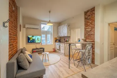 a living room with a couch and a kitchen at 'Blue Sapphire House'- central&modern in Sofia